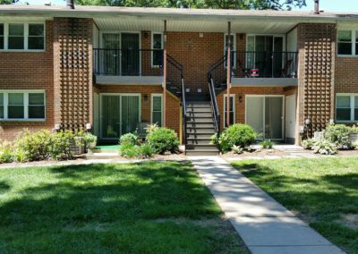 Far shot of the Radwyn apartment complex with well-maintained yard and sturdy stairs in Bryn Mawr
